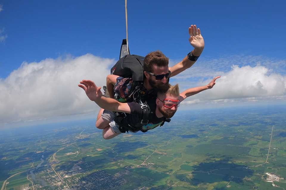 Tandem skydiver and his instructor in freefall