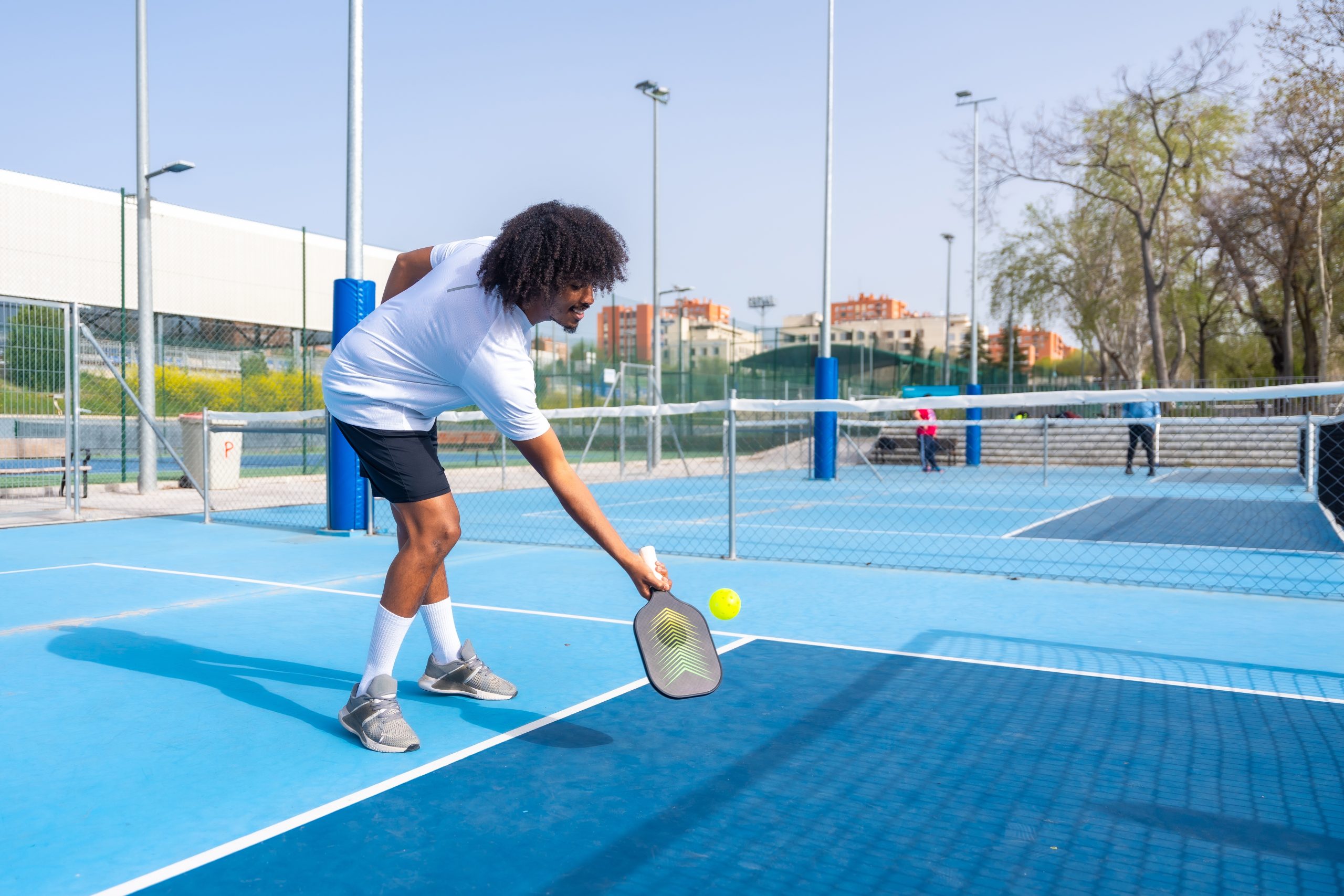 African American man plays pickleball 